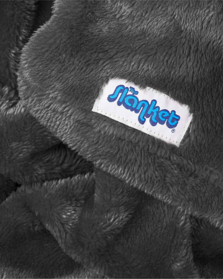 Close-up of gray fleece with the blue Slanket logo tag