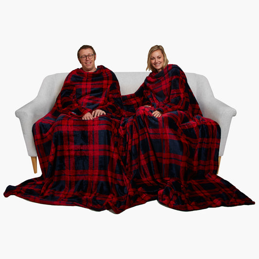 Slanket Siamese - The Original Blanket with Sleeves shown being used by a couple on a couch