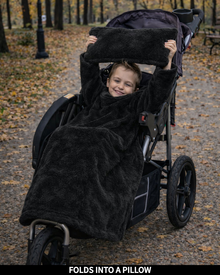 Product Images of Stroller Slanket folded into a pillow being held up by the child