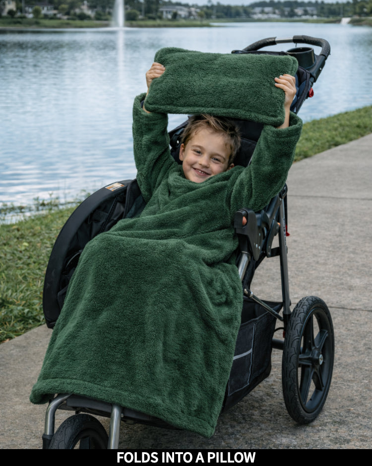 Product Images of Stroller Slanket folded into a pillow being held up by the child