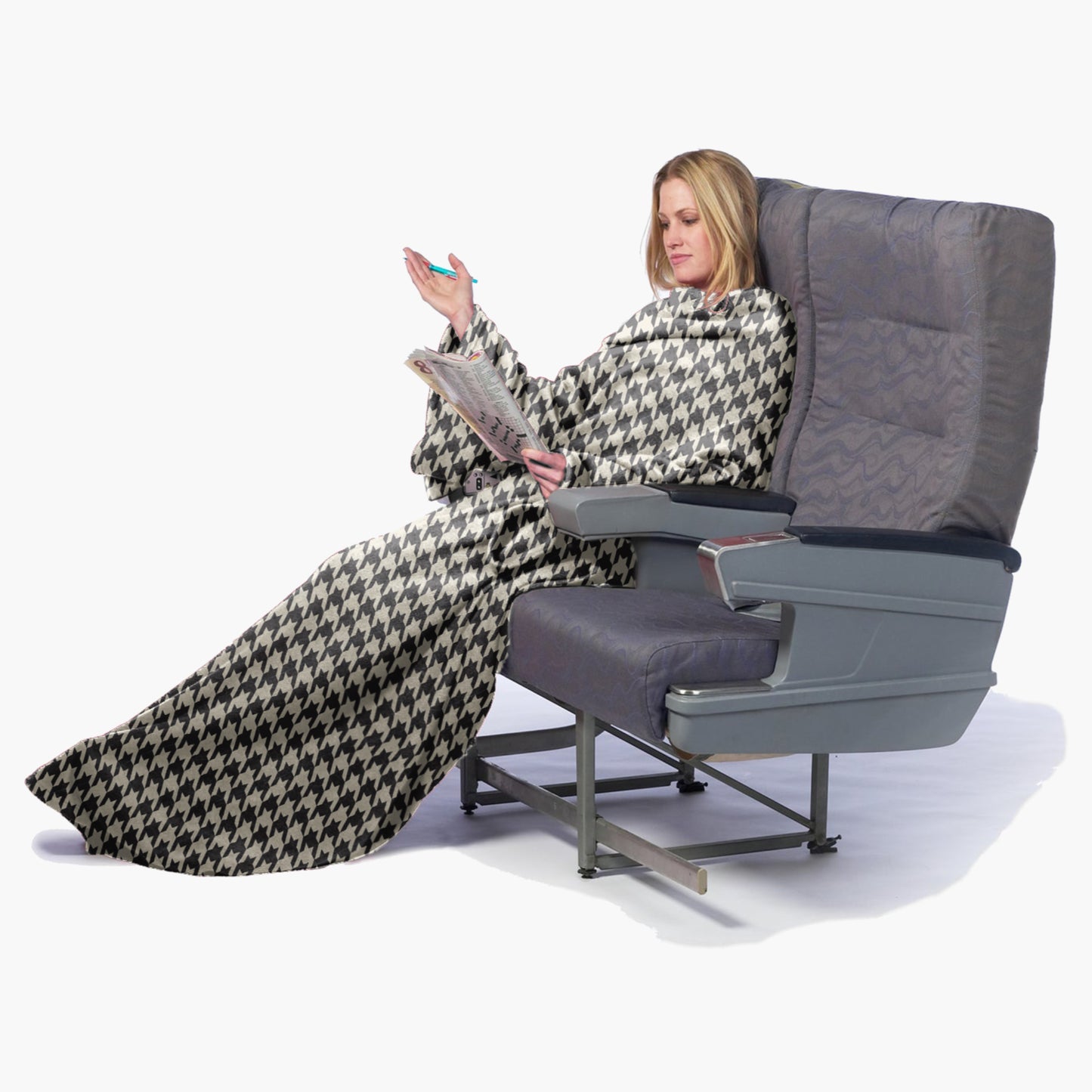 The Ultimate Slanket - The Original Blanket with Sleeves. Women using it while sitting in airplane seat doing a crosswords puzzle