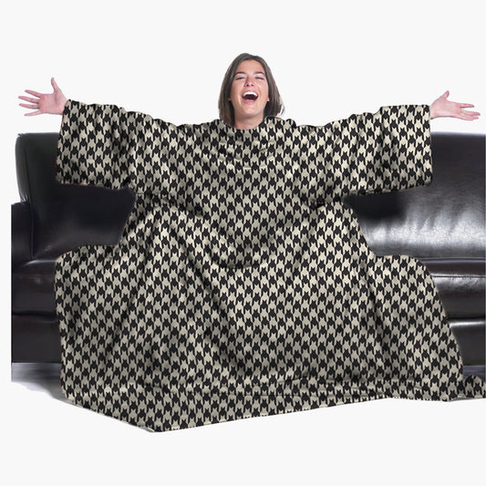 The Ultimate Slanket - The Original Blanket with Sleeves. Women using it on a couch with arms spread out with big smile