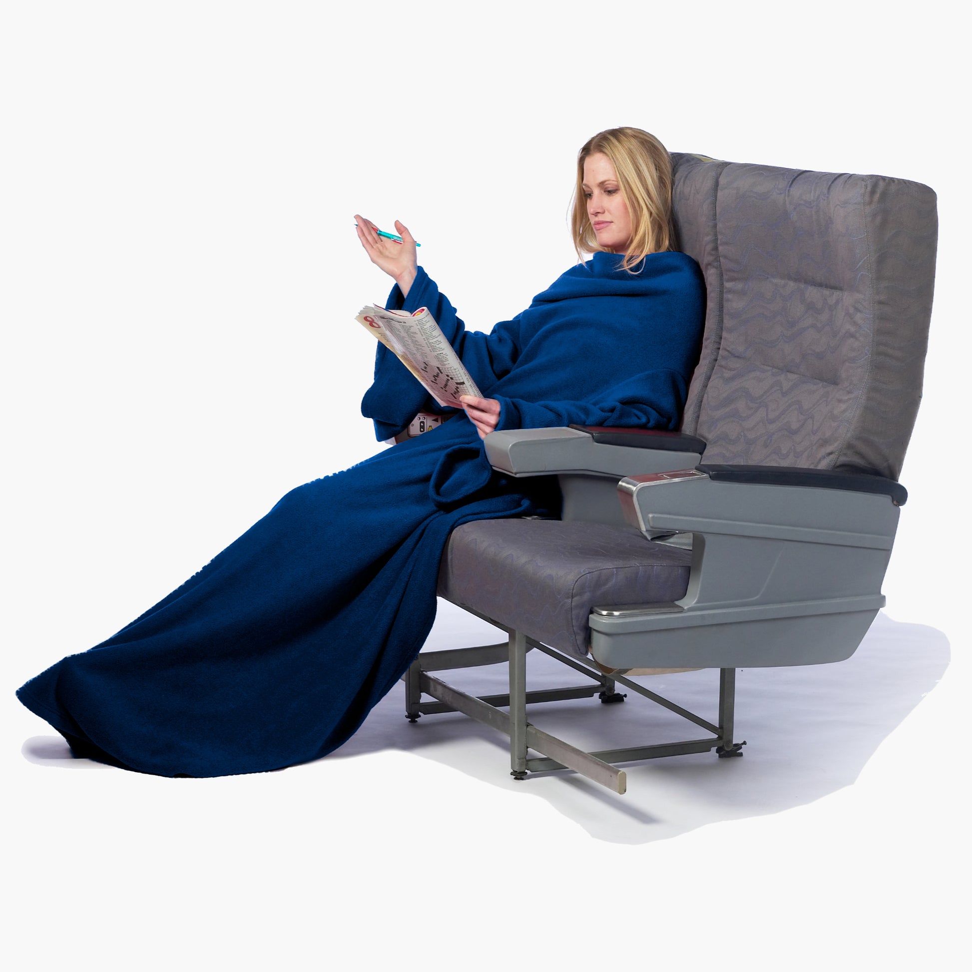The Ultimate Slanket - The Original Blanket with Sleeves. Women using it while sitting in airplane seat doing a crosswords puzzle