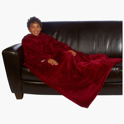 Ultimate Kids Slanket - The Original Blanket with Sleeves shown being used by a kid on a couch