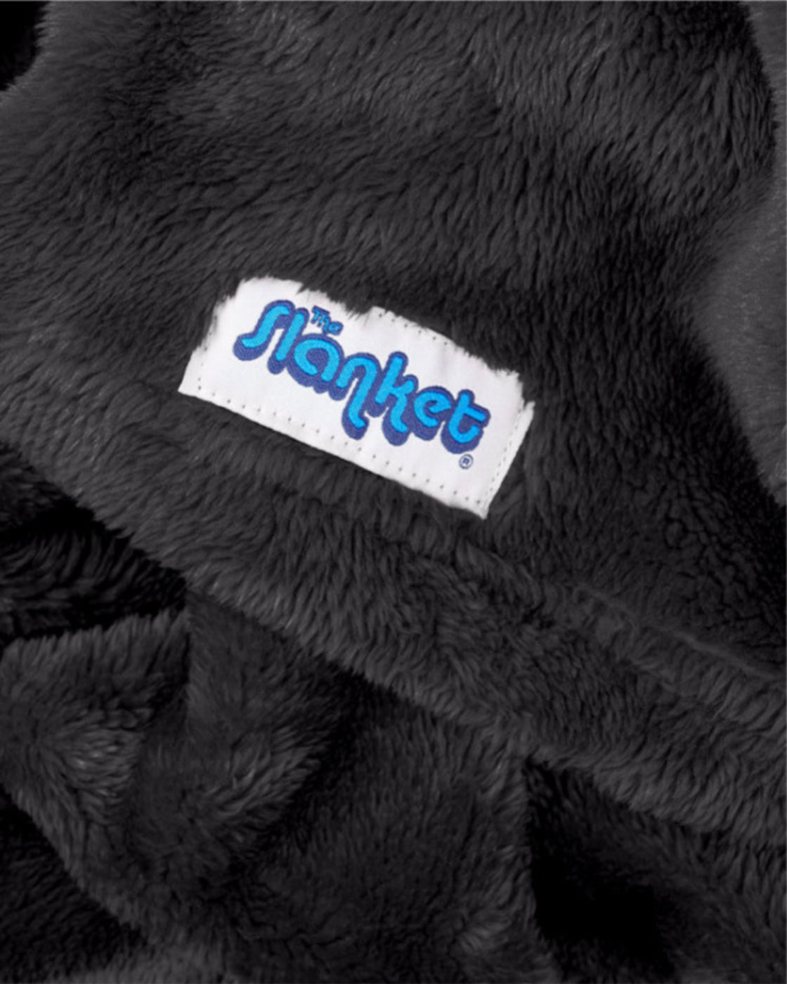Close-up of black fleece with the blue Slanket logo tag