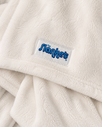 Close-up of soft white fleece with the blue Slanket logo tag