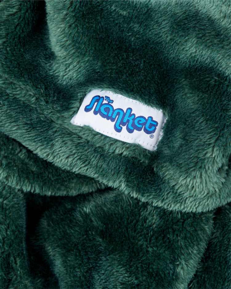 Close-up of hunter green fleece with the blue Slanket logo tag