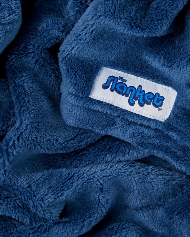 Close-up of royal blue fleece with the blue Slanket logo tag