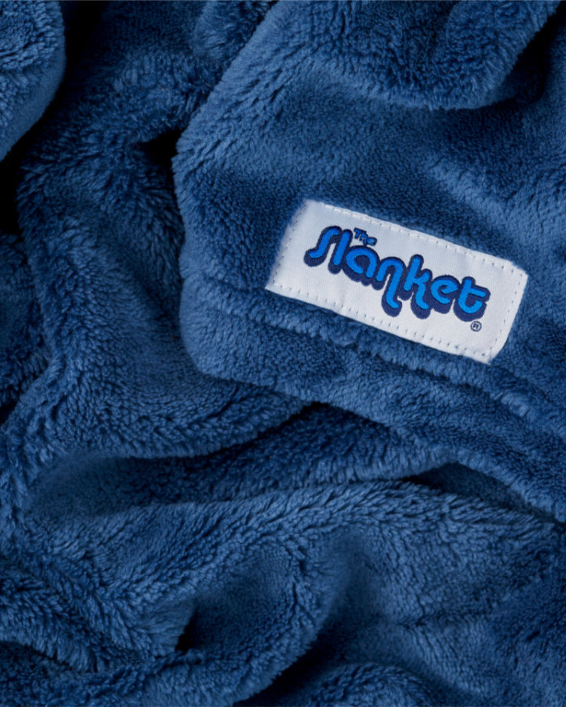 Close-up of royal blue fleece with the blue Slanket logo tag