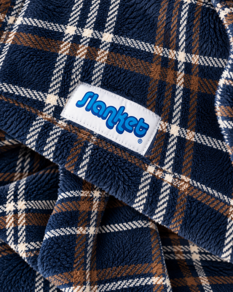 Close-up of navy and blue plaid fleece with the blue Slanket logo tag