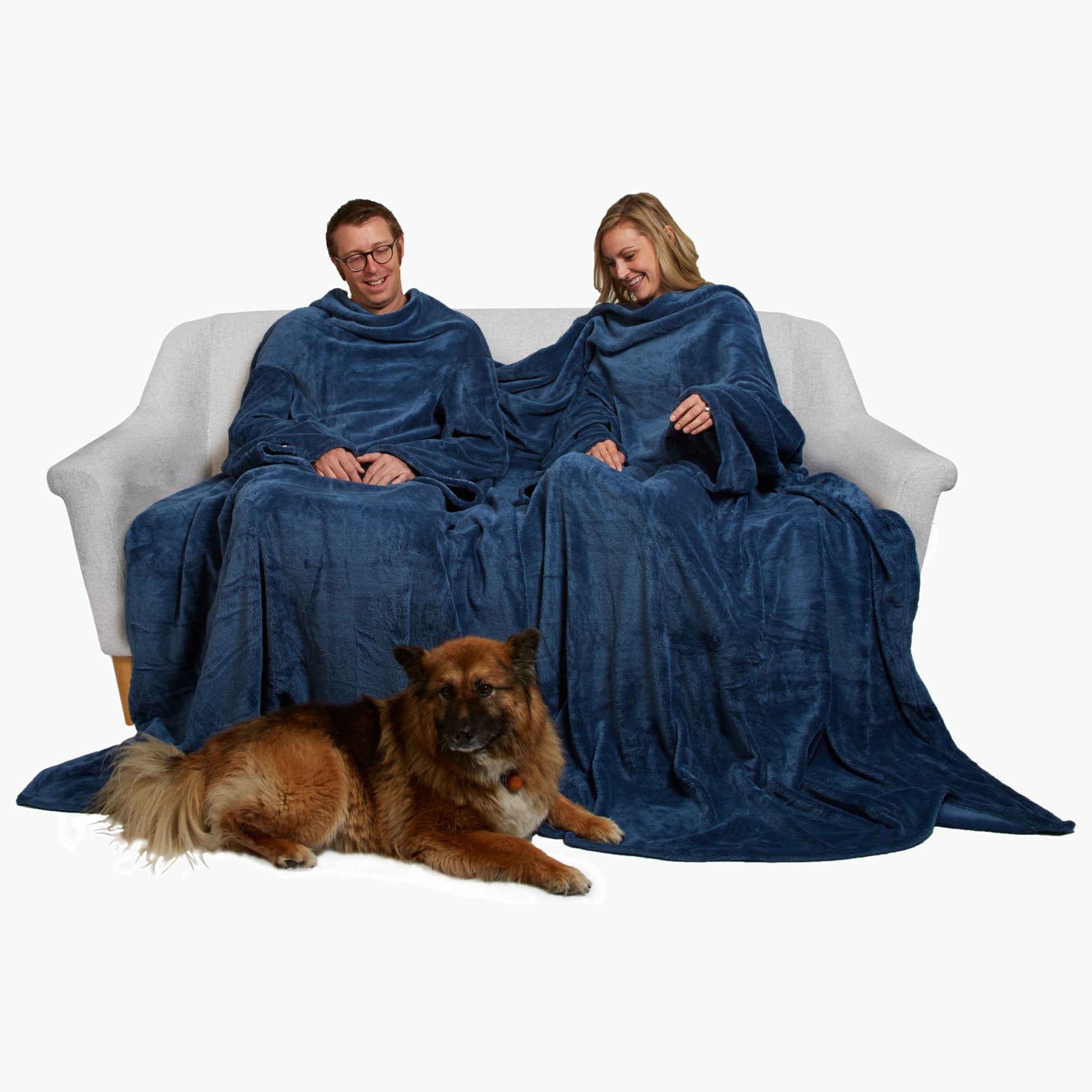 Slanket Siamese - The Original Blanket with Sleeves shown being used by a couple on a couch