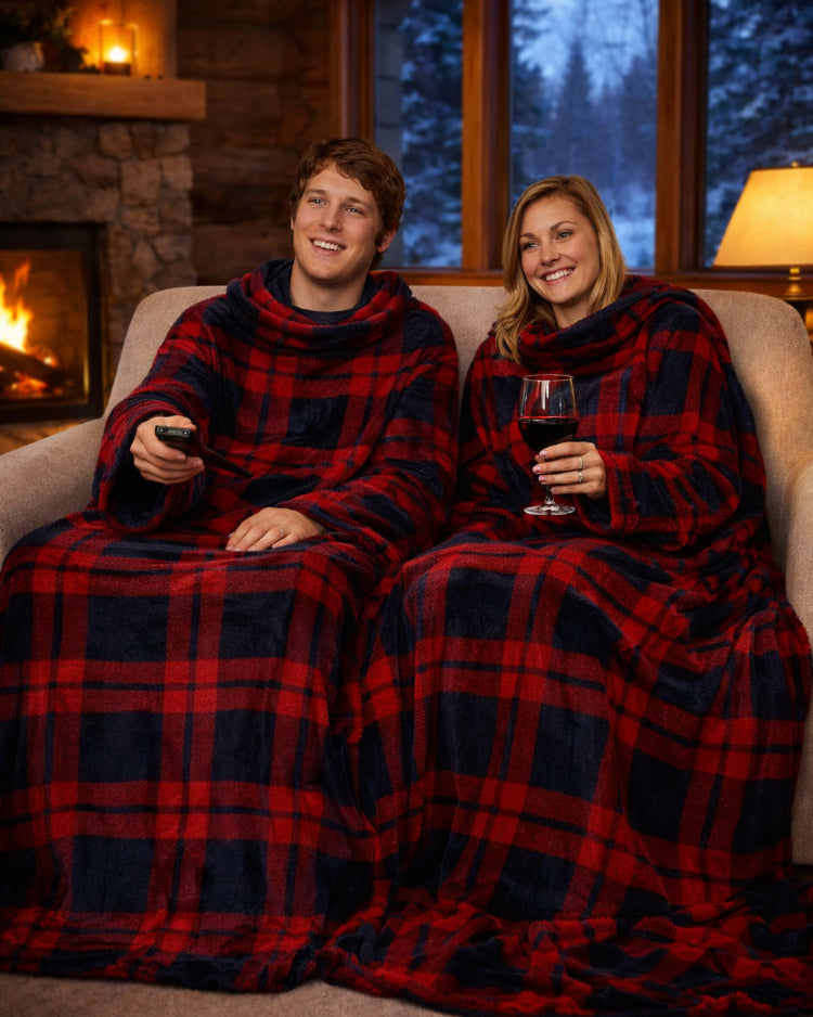 Product image of a man and women using Slanket Siamese and hanging out watching tv with her having a glass of wine