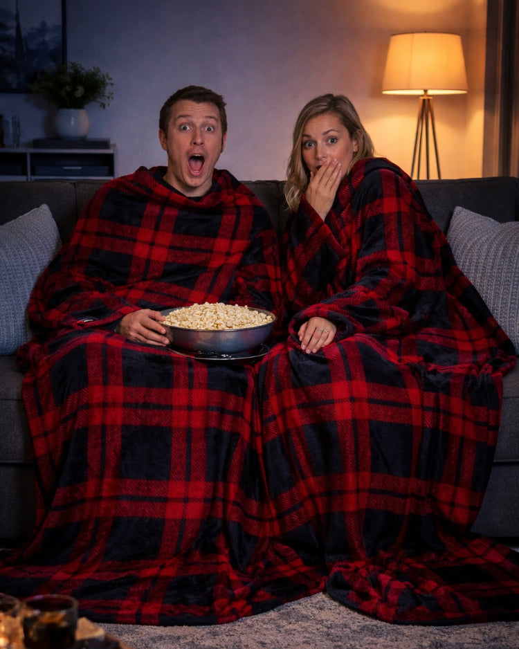 Product image of a man and a women using Slanket Siamese and with popcorn watching a movie
