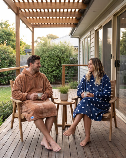 Couple on a porch, the man in a Mocha Mousse Slanket Long Hoodie and the woman in Navy Polka