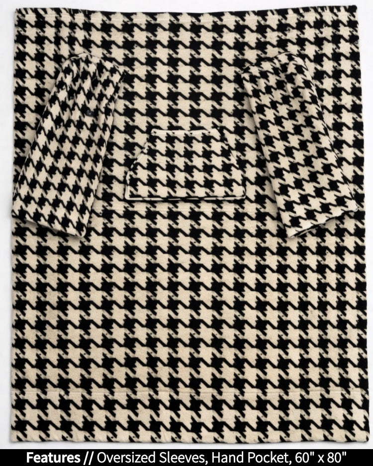 Houndstooth Slanket laid flat, front view, with callouts for oversized sleeves and hand pocket, 60 x 80 in