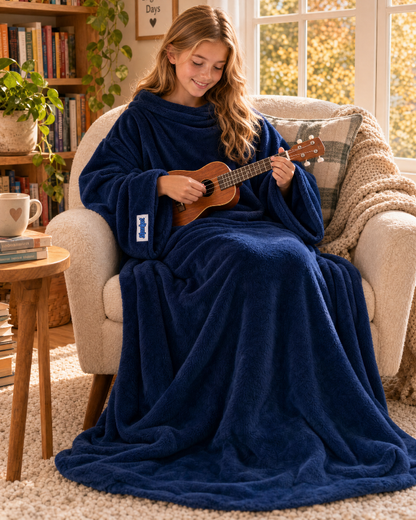 Girl in a Dark Blue Slanket Jr. playing the ukulele in an armchair