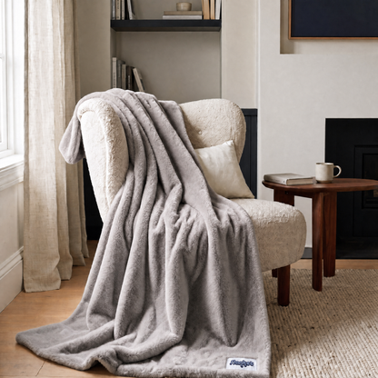 Slanket Rogue plush throw in Shadow gray draped over an armchair