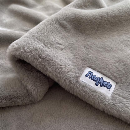 Close-up of Shadow gray plush with the blue Slanket logo tag