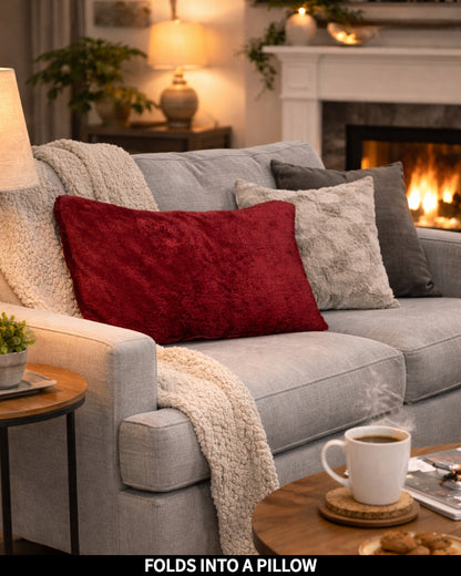 Ruby Wine Slanket folded into a pillow, shown as a decorative cushion, captioned Folds Into a Pillow