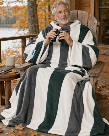 Older woman holding a cup in an armchair, wearing a Pines Stripe Slanket