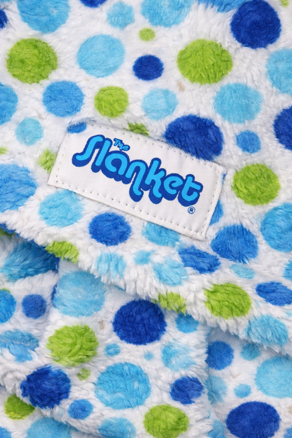 Product image, close up shot of the logo on the sleeves and showing the soft plush feel of the material