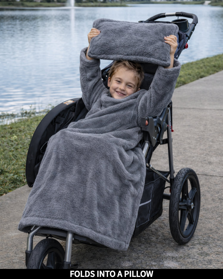 Product Images of Stroller Slanket folded into a pillow being held up by the child