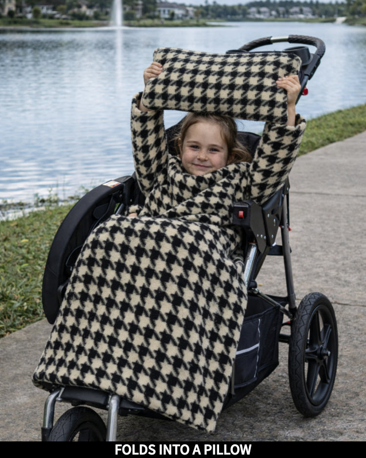 Product Images of Stroller Slanket folded into a pillow being held up by the child
