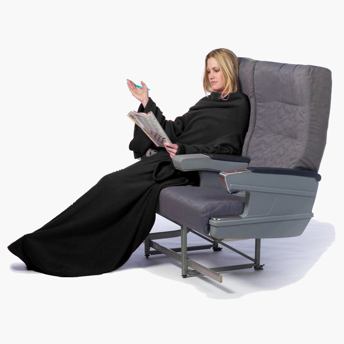 The Ultimate Slanket - The Original Blanket with Sleeves. Women using it while sitting in airplane seat doing a crosswords puzzle