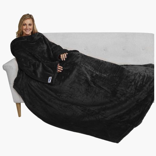 The Ultimate Slanket - The Original Blanket with Sleeves. Women using it on a couch.