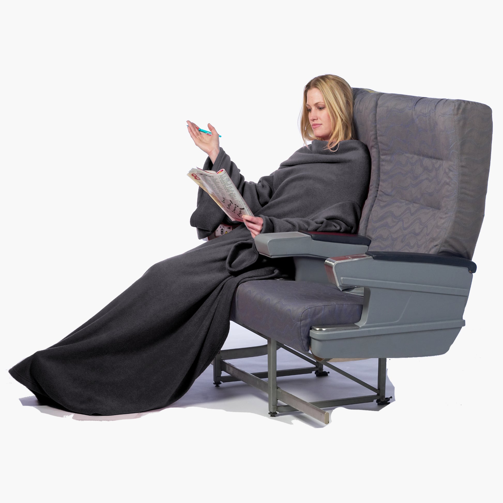 The Ultimate Slanket - The Original Blanket with Sleeves. Women using it while sitting in airplane seat doing a crosswords puzzle