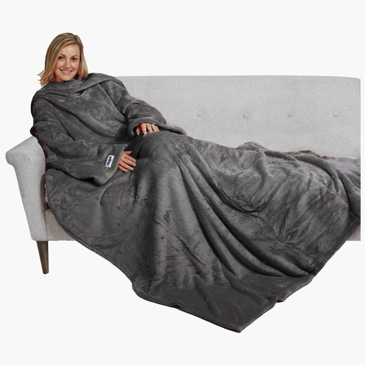 The Ultimate Slanket - The Original Blanket with Sleeves. Women using it on a couch.