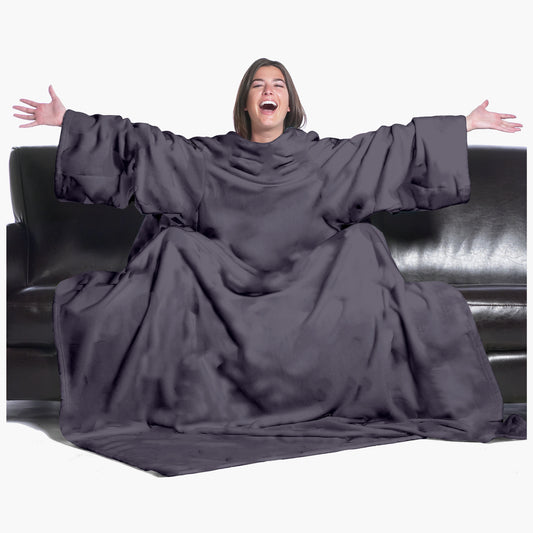 The Ultimate Slanket - The Original Blanket with Sleeves. Women using it on a couch with arms spread out with big smile 