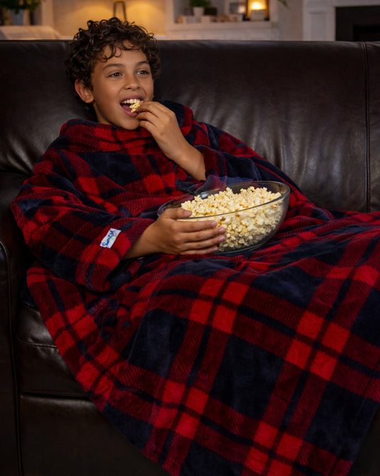 Product image of a young man using Slanket and eating popcorn watching tv