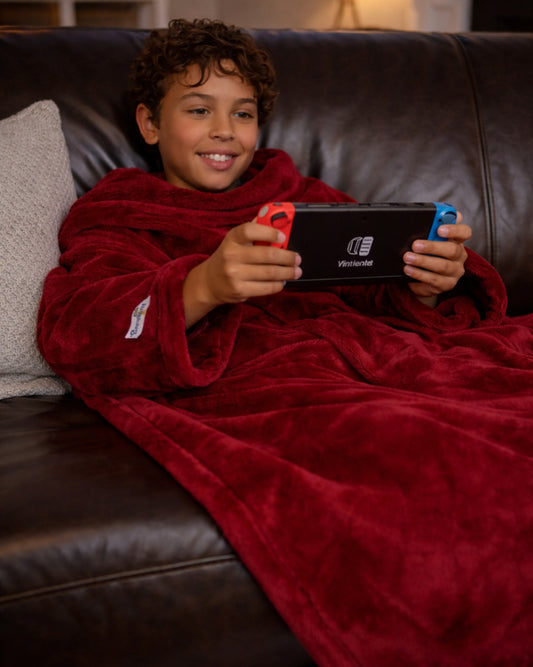 Product image of a young man using Slanket and playing video games