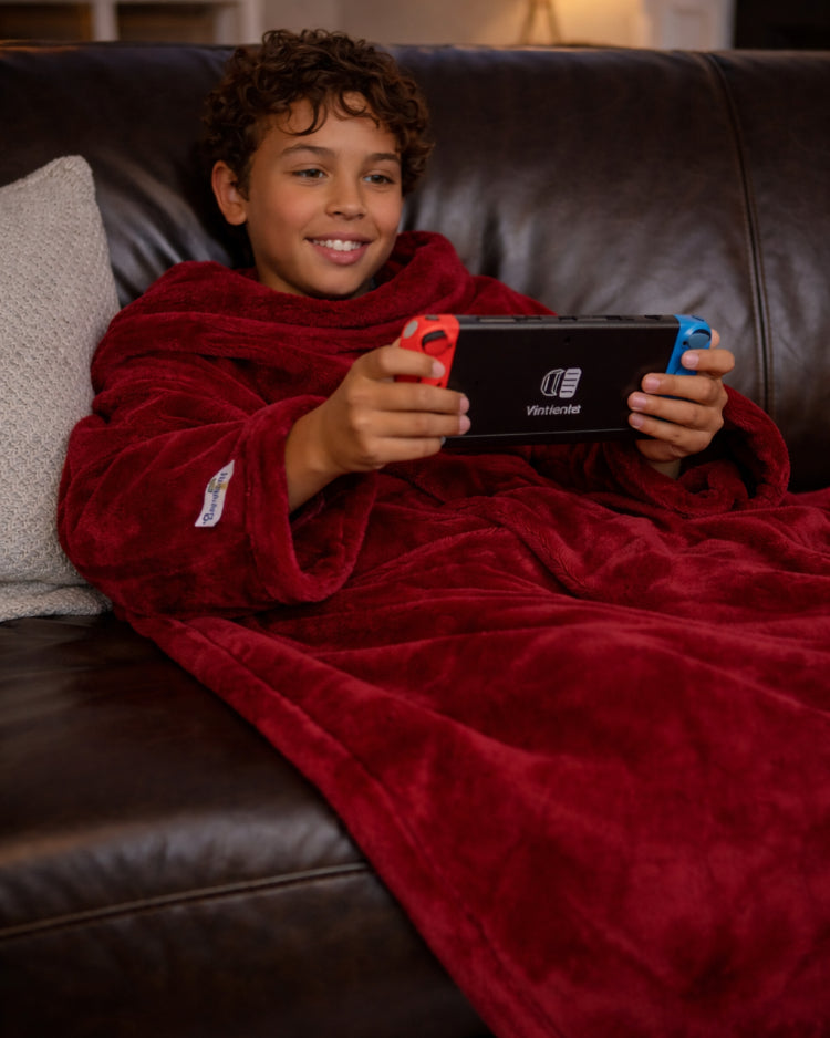 Product image of a young man using Slanket and playing video games
