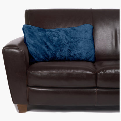 Slanket - The Original Blanket with Sleeves folds into a couch cushion which is laying on a couch