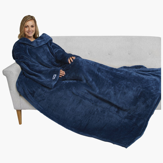 The Ultimate Slanket - The Original Blanket with Sleeves. Women using it on a couch.