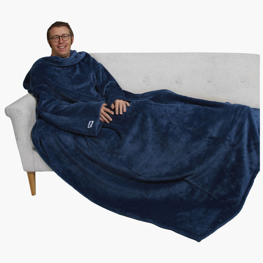 The Ultimate Slanket - The Original Blanket with Sleeves. Man using it on a couch.