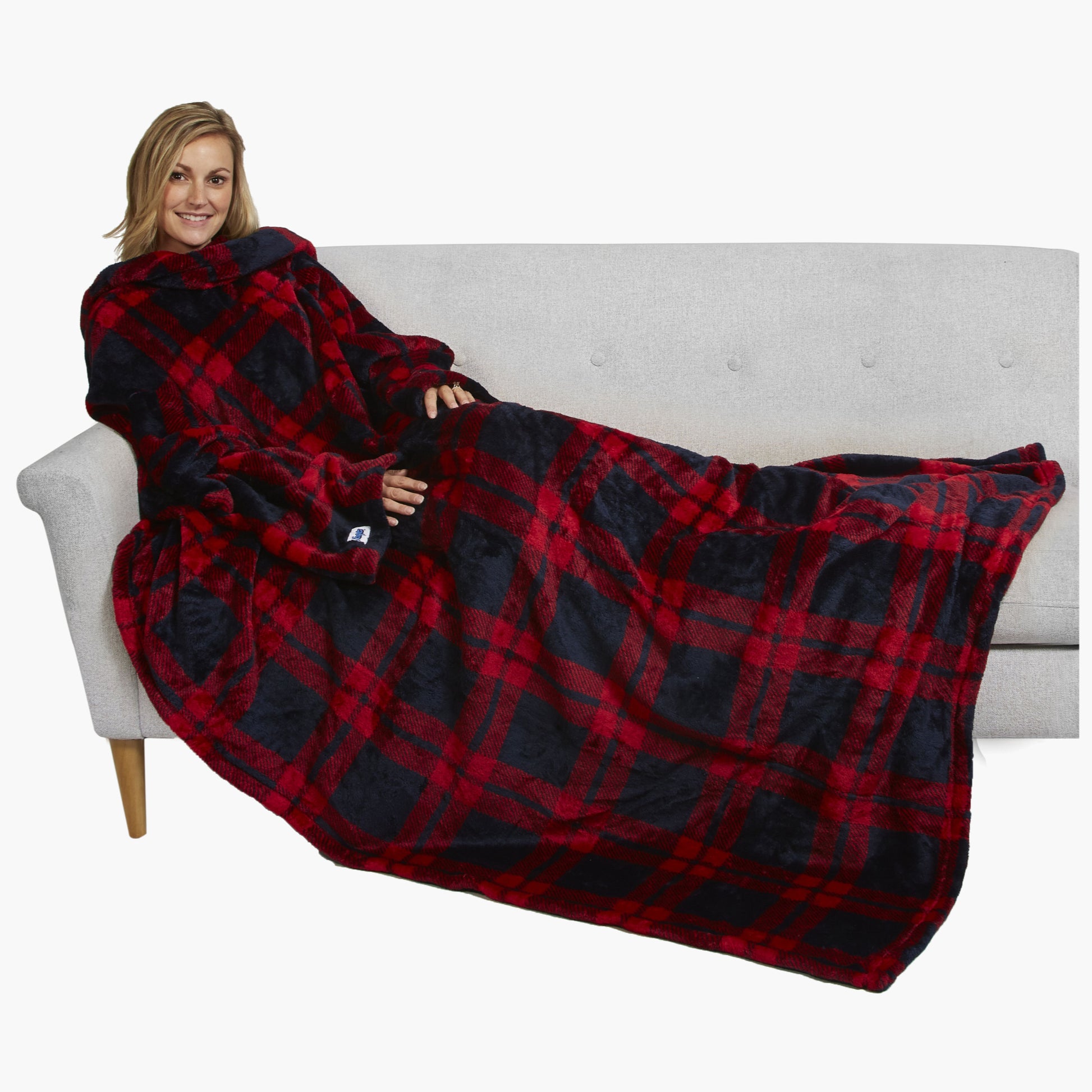 The Ultimate Slanket - The Original Blanket with Sleeves. Women using it on a couch.