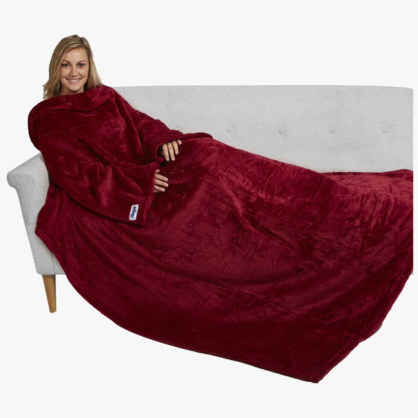 The Ultimate Slanket - The Original Blanket with Sleeves. Women using it on a couch.