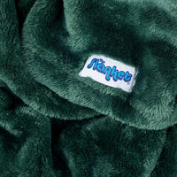 Close-up of hunter green fleece with the blue Slanket logo tag